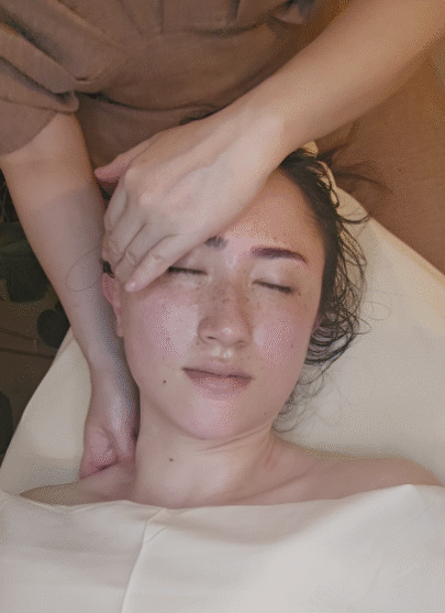 a woman getting lymphatic drainage facial massage